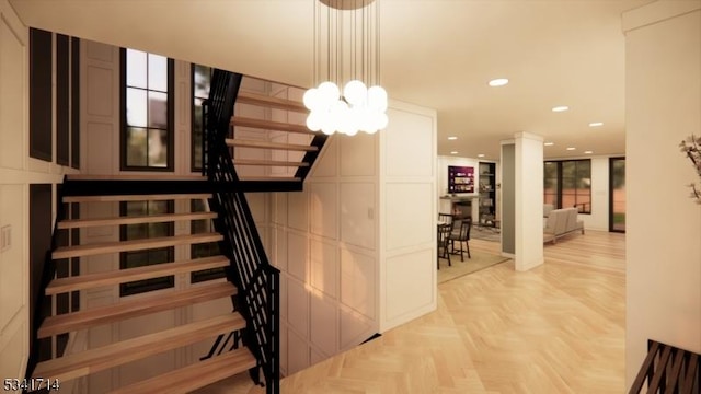 stairway featuring a chandelier, recessed lighting, and decorative columns