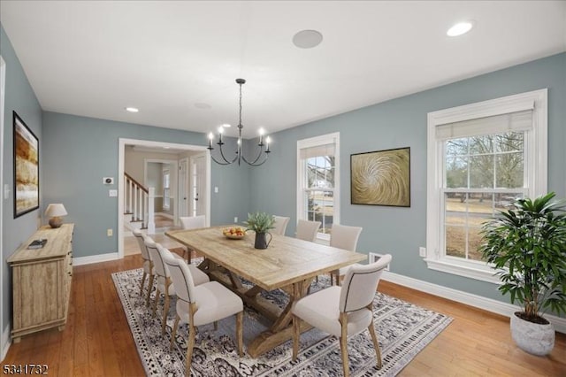 dining room featuring recessed lighting, stairway, wood finished floors, a chandelier, and baseboards