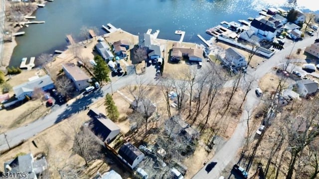 birds eye view of property featuring a water view and a residential view