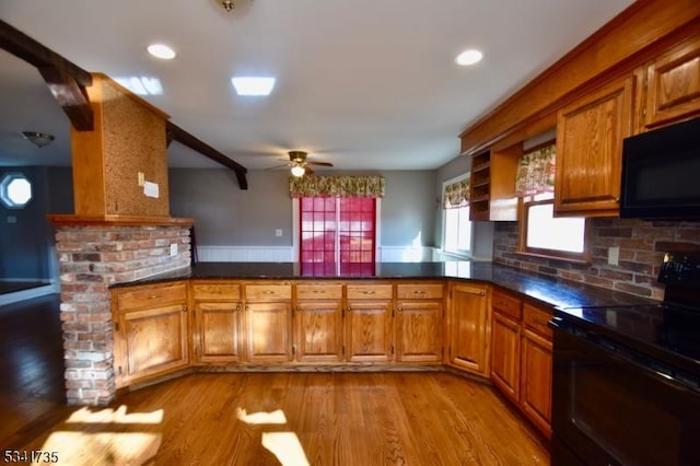 kitchen featuring black appliances, light wood-style floors, a peninsula, and brown cabinets