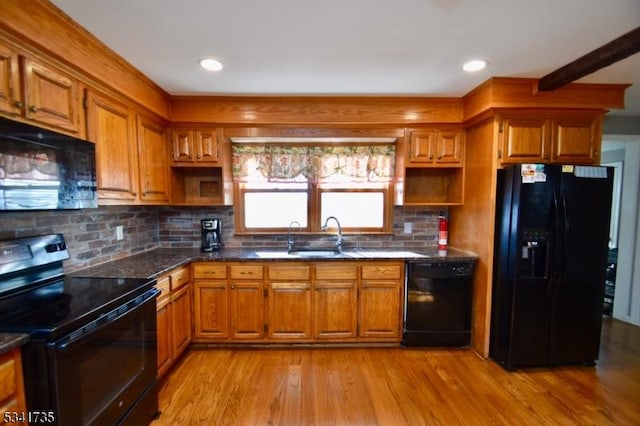 kitchen with open shelves, a sink, light wood-style floors, brown cabinets, and black appliances