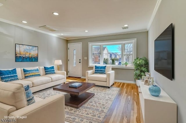 living area with crown molding, recessed lighting, visible vents, light wood-style flooring, and baseboards