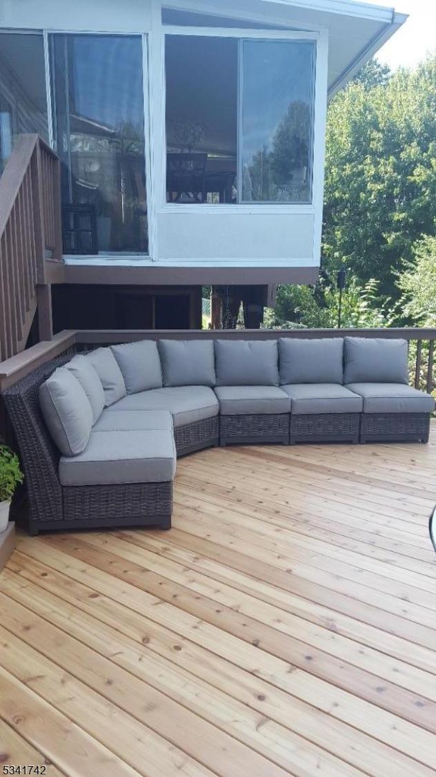 wooden terrace featuring outdoor lounge area