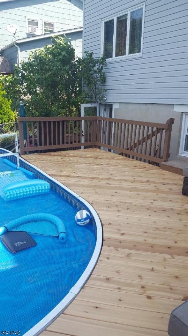 view of swimming pool with a deck