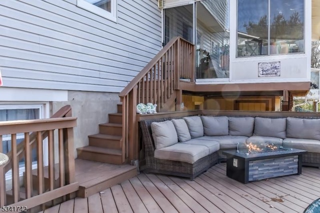 wooden deck featuring stairs and an outdoor living space with a fire pit