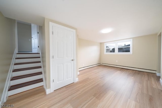 interior space with stairs, light wood-type flooring, and baseboards