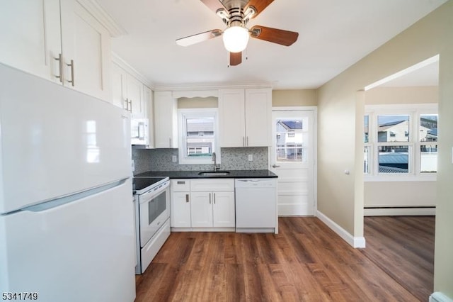 kitchen featuring a baseboard heating unit, white appliances, white cabinets, and a sink