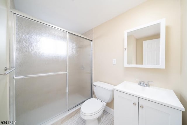 bathroom with a stall shower, tile patterned flooring, vanity, and toilet