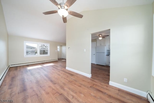 interior space featuring baseboard heating, a baseboard heating unit, wood finished floors, high vaulted ceiling, and baseboards