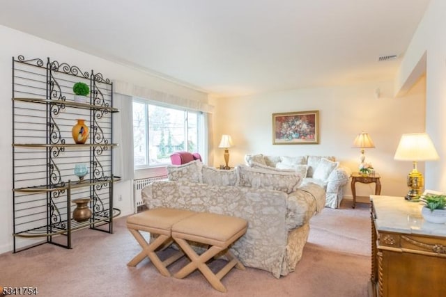 carpeted bedroom with visible vents and radiator