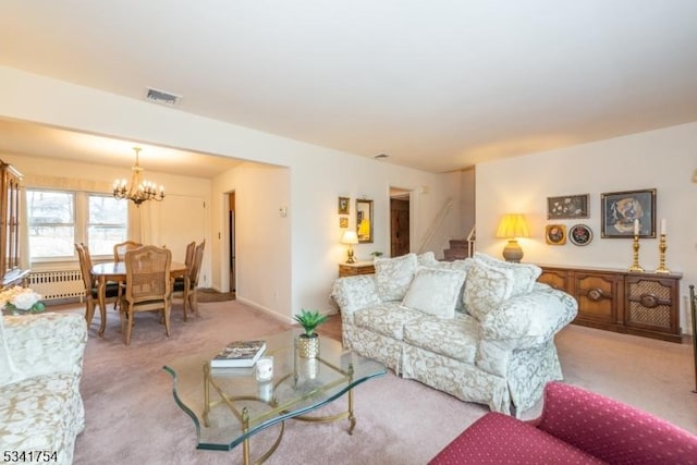 carpeted living room with stairway, visible vents, a chandelier, and baseboards