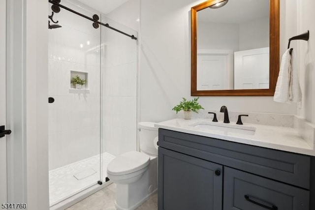 bathroom featuring a stall shower, vanity, and toilet