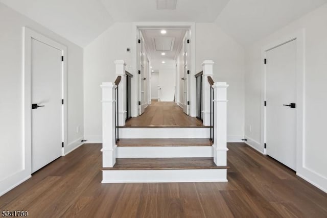 stairs featuring baseboards, vaulted ceiling, and wood finished floors