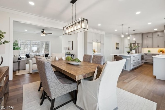 dining area with ceiling fan, ornamental molding, wood finished floors, and recessed lighting