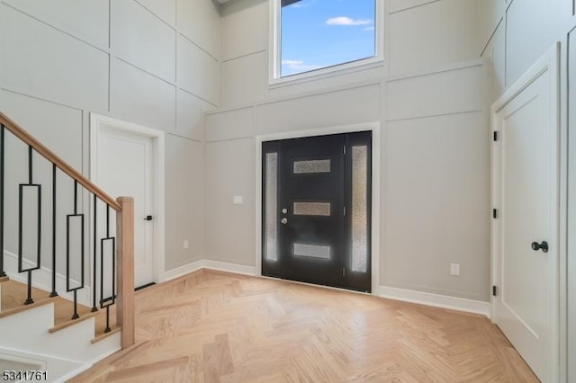 entrance foyer featuring a high ceiling and stairs