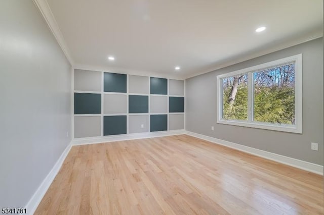 unfurnished room with built in features, crown molding, recessed lighting, light wood-type flooring, and baseboards