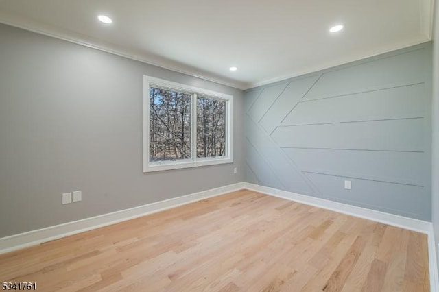 empty room featuring recessed lighting, light wood-type flooring, and baseboards