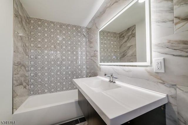 full bathroom featuring shower / bathtub combination, tile walls, and vanity