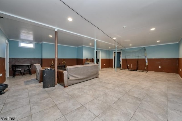 interior space with a wainscoted wall, wood walls, and recessed lighting