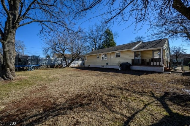 view of home's exterior with a trampoline and a yard