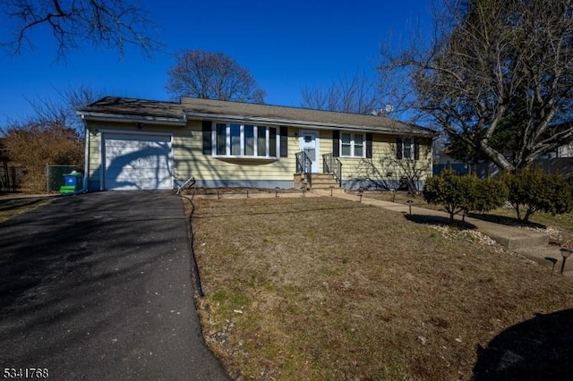 ranch-style house with aphalt driveway and an attached garage