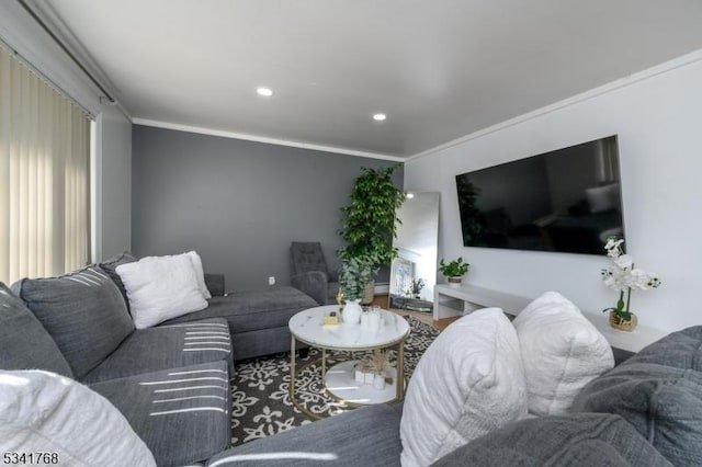 living area featuring recessed lighting and crown molding