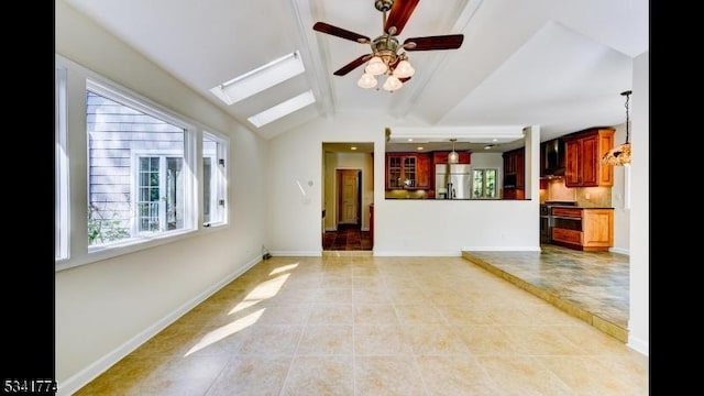 unfurnished living room featuring light tile patterned floors, ceiling fan, lofted ceiling with skylight, and baseboards