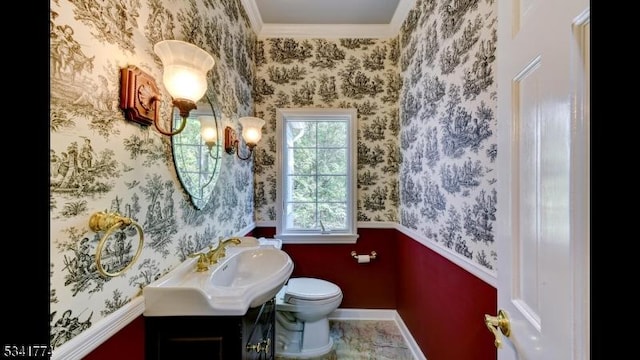 bathroom featuring wallpapered walls, toilet, vanity, and baseboards