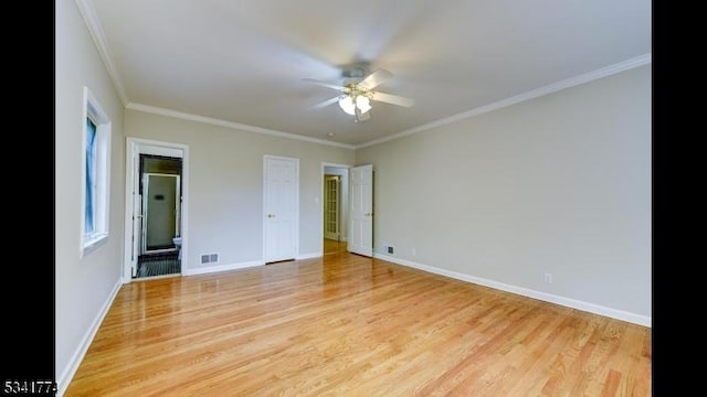 unfurnished room with visible vents, light wood-style flooring, and baseboards