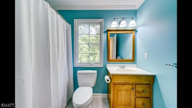 bathroom featuring tile patterned floors, toilet, ornamental molding, baseboards, and vanity