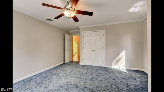 unfurnished bedroom featuring visible vents, baseboards, carpet, and ornamental molding