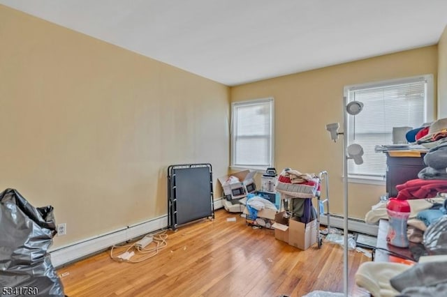 interior space with a baseboard heating unit, light wood-style floors, and a baseboard radiator