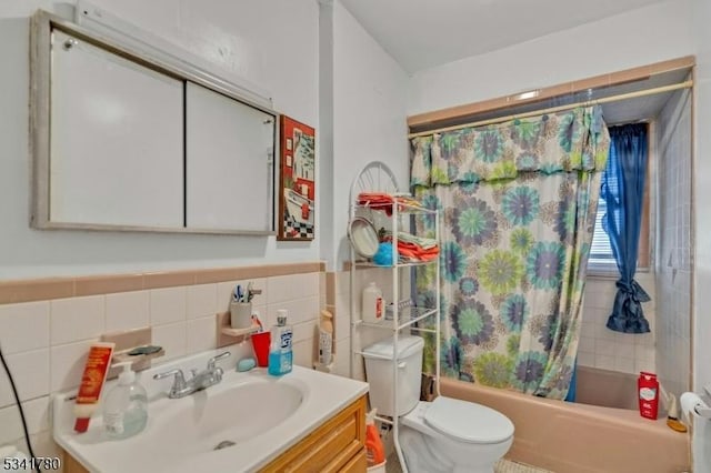 bathroom featuring vanity, tile walls, toilet, and shower / tub combo with curtain