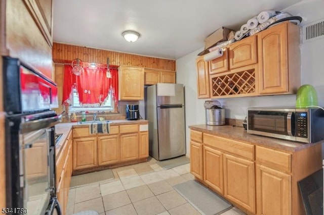 kitchen featuring a sink, stainless steel appliances, visible vents, and light countertops