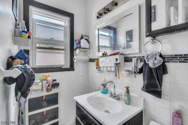 bathroom featuring vanity and tile walls