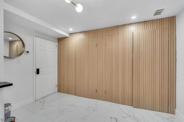 interior space featuring recessed lighting, visible vents, baseboards, and marble finish floor