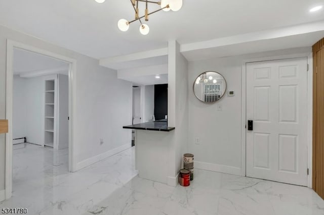 interior space featuring marble finish floor, a baseboard heating unit, and baseboards