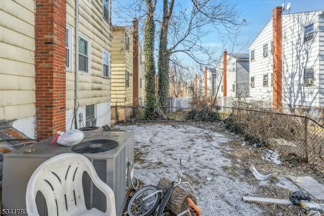 view of yard with central AC unit and fence