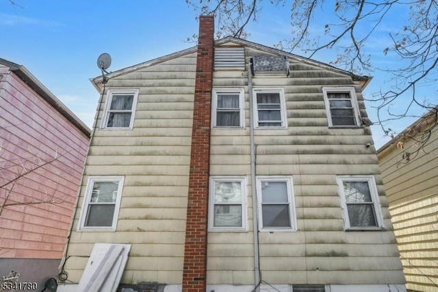 view of side of home with a chimney