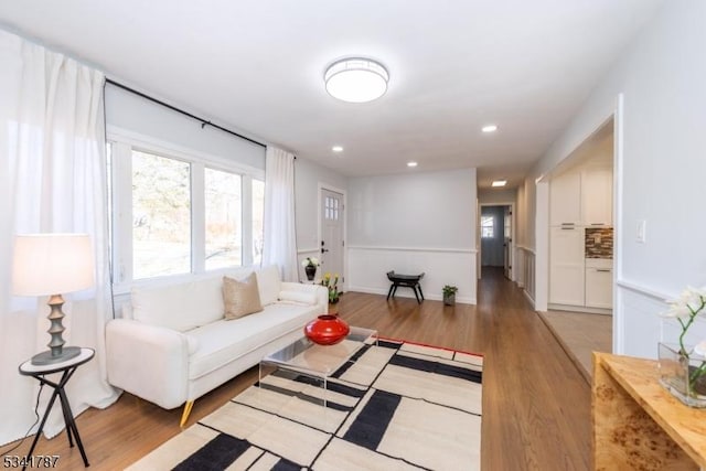 living area with recessed lighting and light wood-style floors