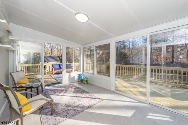 unfurnished sunroom with lofted ceiling