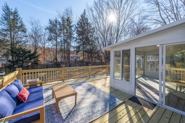 wooden terrace with a sunroom and fence