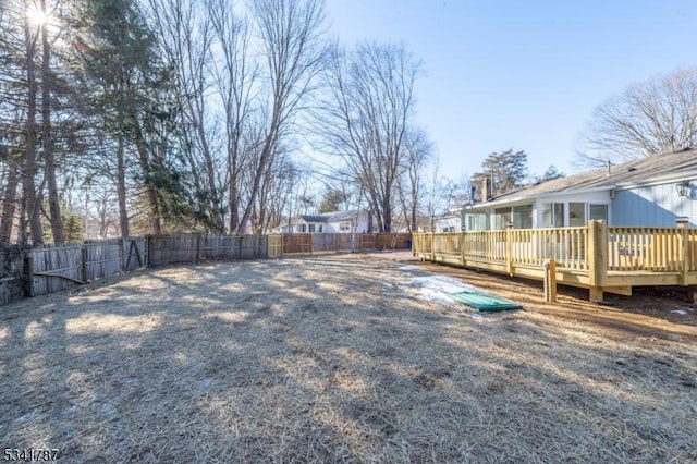 view of yard with a fenced backyard and a deck