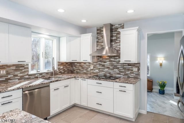 kitchen with black electric stovetop, a sink, wall chimney range hood, dishwasher, and tasteful backsplash