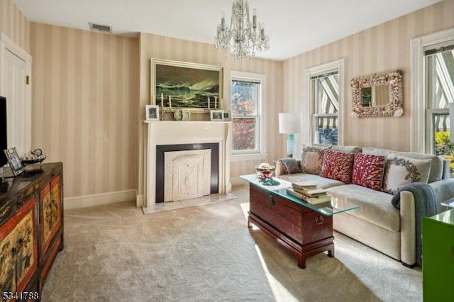 living room with a chandelier, visible vents, baseboards, carpet, and wallpapered walls