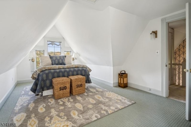 bedroom with carpet flooring, vaulted ceiling, and baseboards