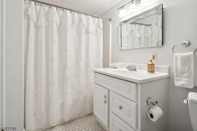 bathroom featuring toilet, tile patterned flooring, vanity, and a shower with curtain