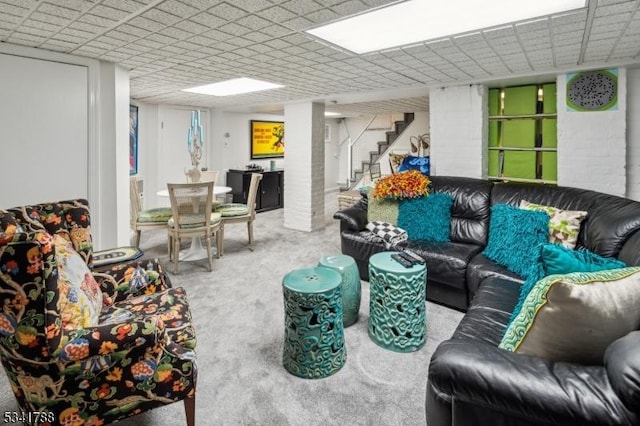 living area featuring stairs and carpet flooring