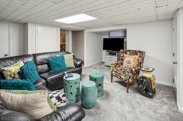 carpeted living area featuring baseboards