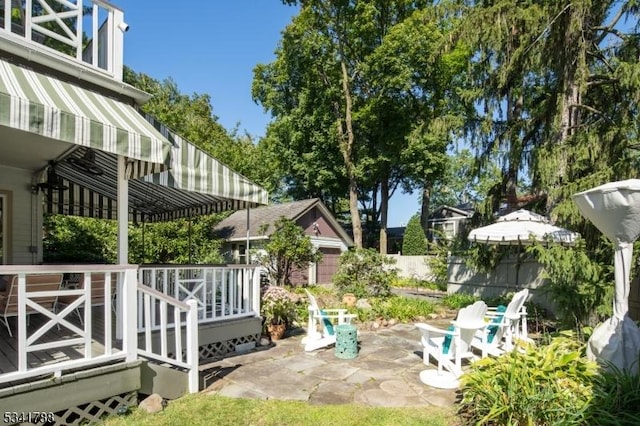 view of yard featuring a patio area, fence, a pergola, and a wooden deck